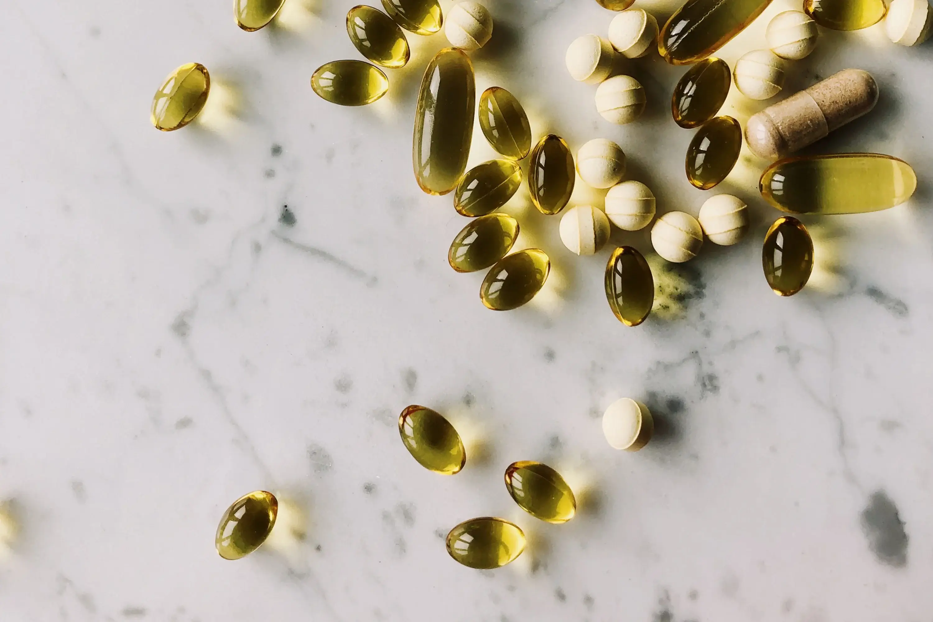 fat soluble vitamins on a marble counter